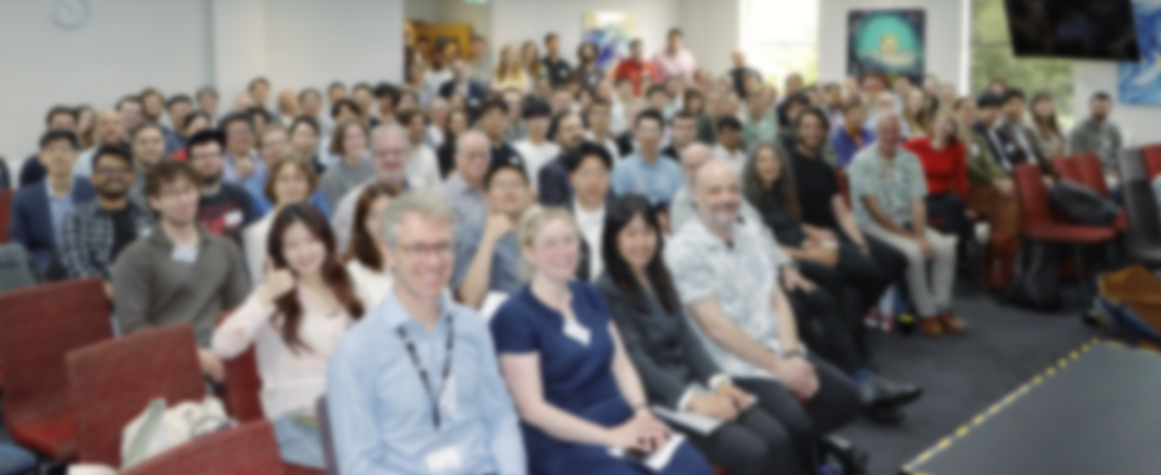 Conference audience (faces blurred)